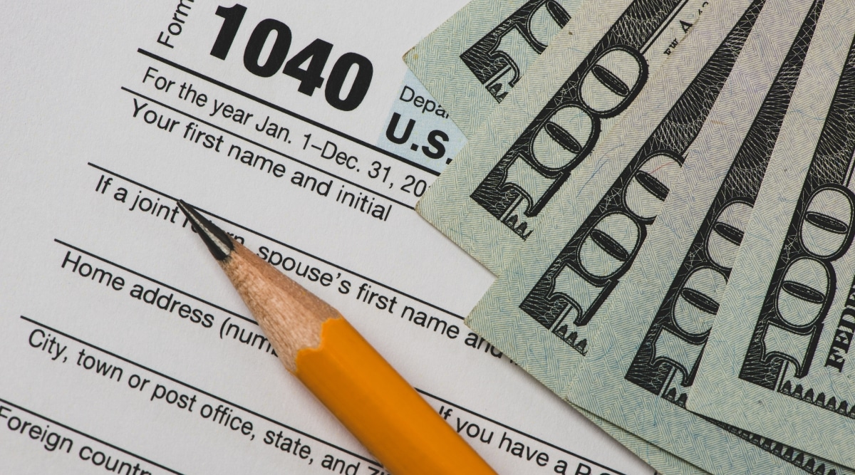 Tax Forms With Pencil and Dollars