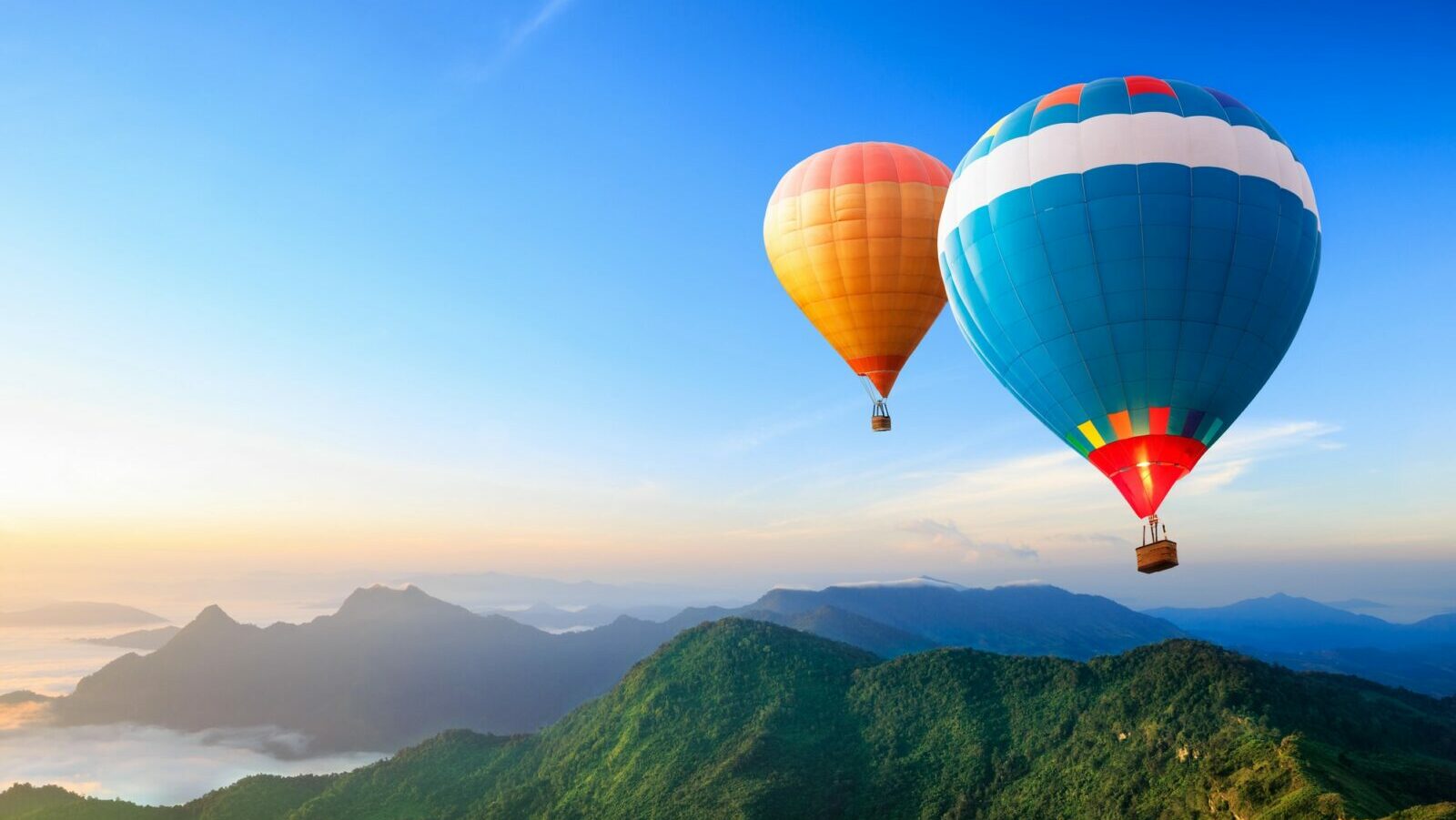 hot air balloons over mountains