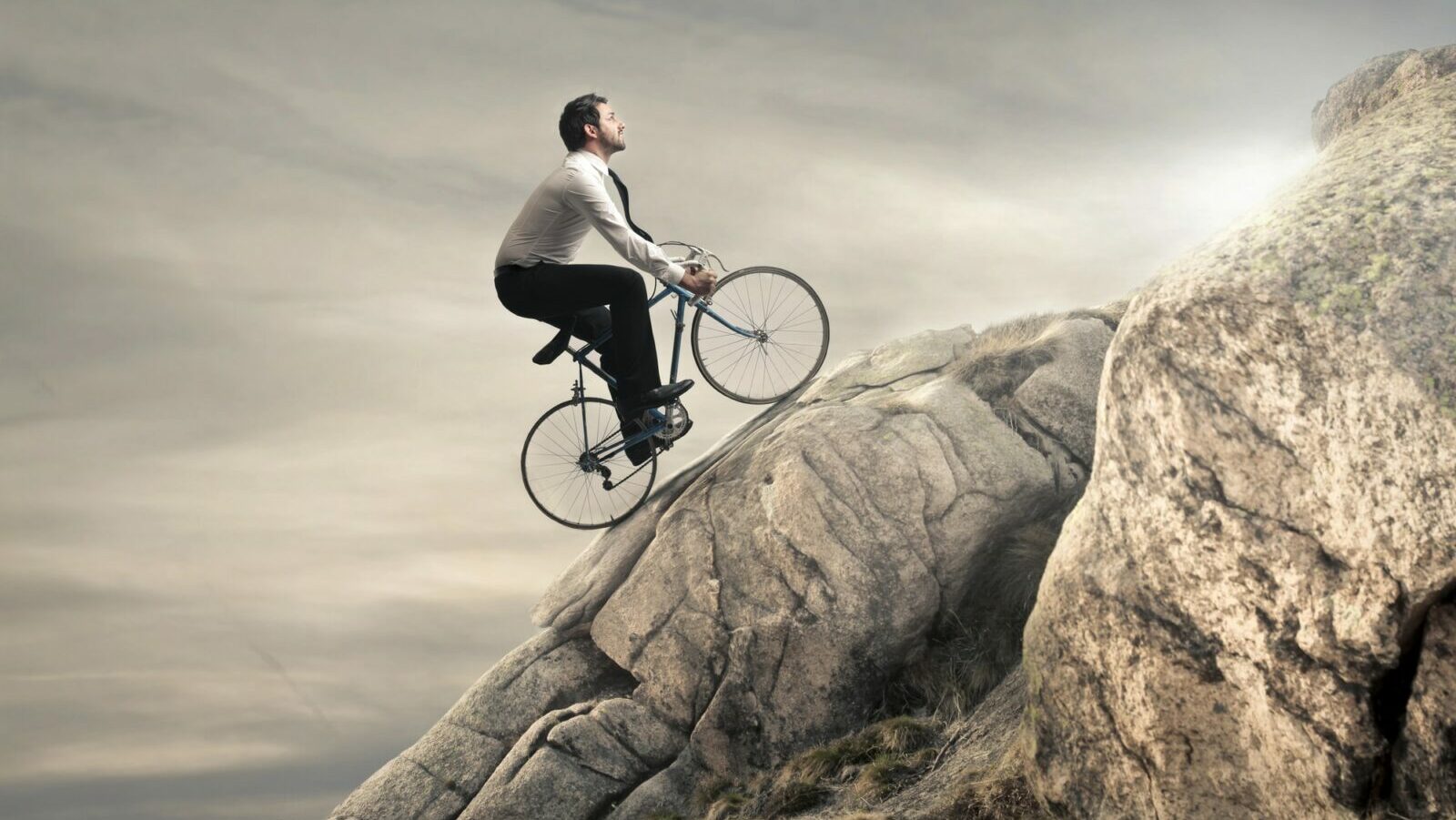 man biking up mountain